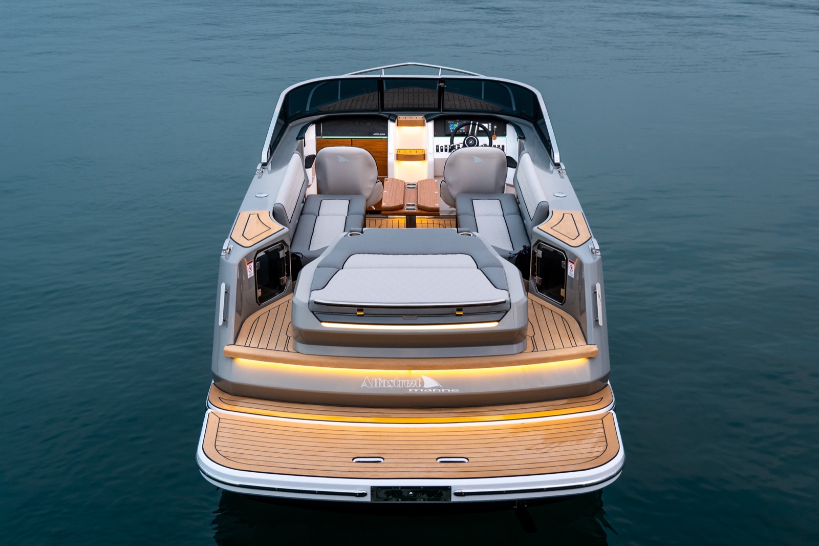 Stern of the Alfastreet 23 Cabin Evo Electric at dusk with the swim platform lit