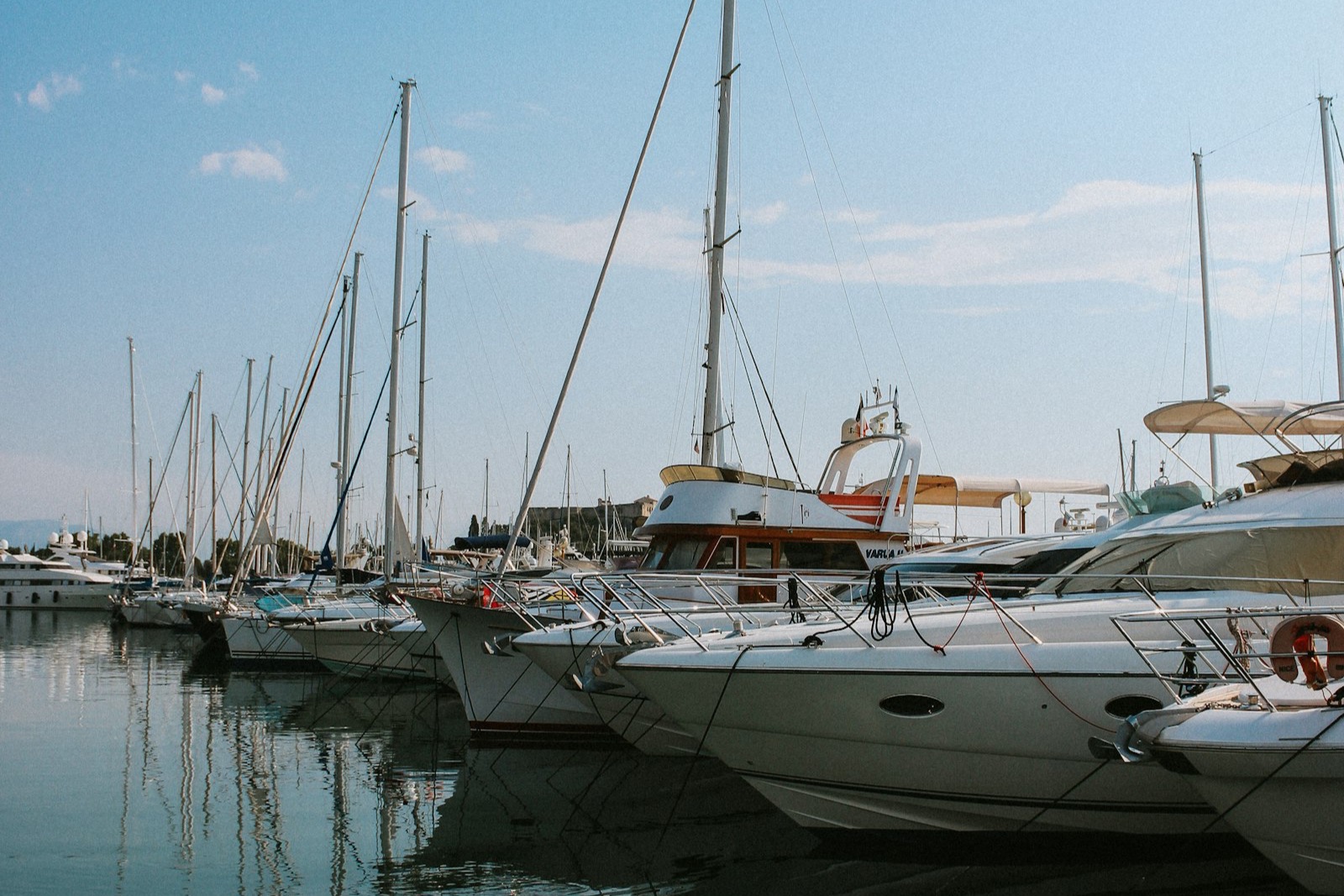 Boats moored in a marina on a summer lake