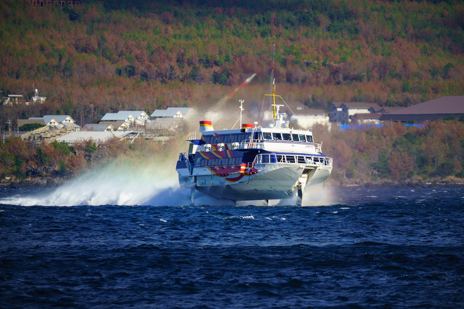 Foiling boat traveling above the water on its hydrofoils
